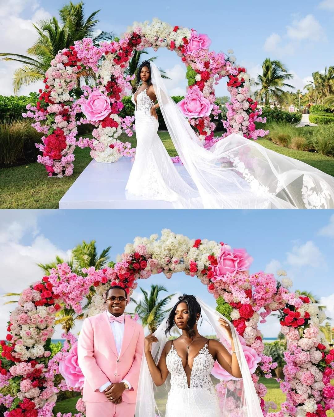 Bride and groom posing under floral arch with pink and white flowers in an outdoor garden setting.