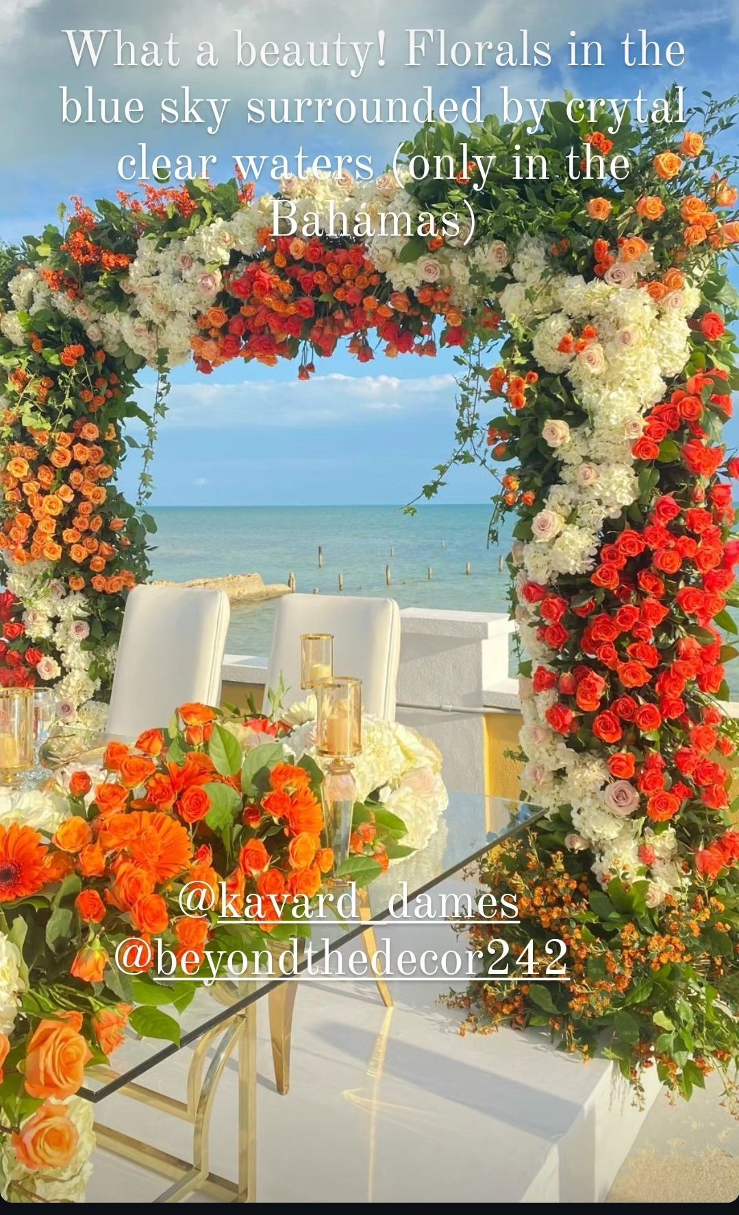 Floral arch and decorated table with ocean view in the Bahamas.